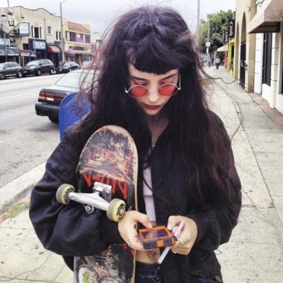 teen witch on phone and skate board